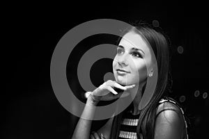 Girl looking at the moon at night, city view, black and white photo