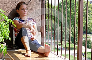 Girl looking out the balcony