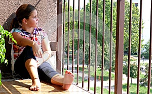 Girl looking out the balcony