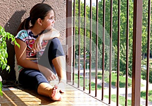 Girl looking out the balcony