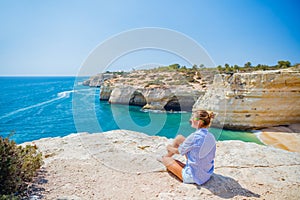 Girl looking out on the ocean. Lagos, Algarve Coast, Portugal