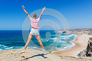 Girl looking out on the ocean. Lagos, Algarve Coast, Portugal