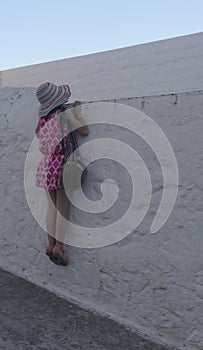 Girl looking over wall