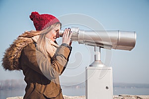 Girl looking through panorama binoculars telescope