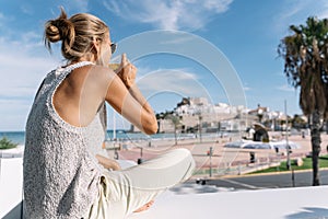 Girl looking at peniscola city, in spain with copyspace photo