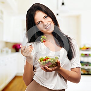 Girl looking positive and holding a bawl with salad