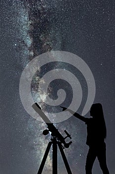 Girl looking at the stars. Telescope Milky Way