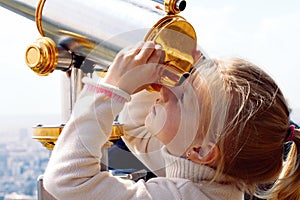 Girl looking through a telescope