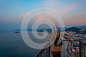 The girl looking to the beautiful landscape of the city of Giresun from the balcony photo