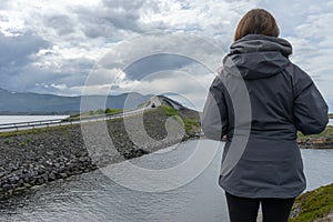 Girl looking towards the atlantic road in Molde/Norway. photo