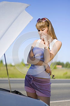 Girl looking under the car