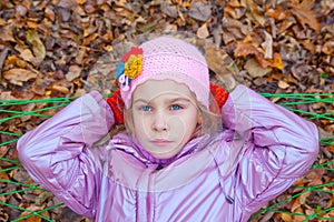 A girl looking up and swinging in a hammock