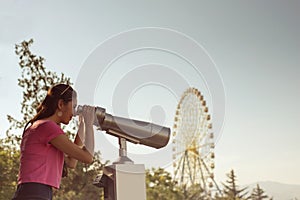 Girl looks through binoculars