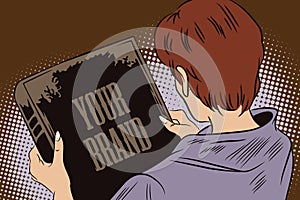Girl looks at the book cover. In the book, you can write your brand