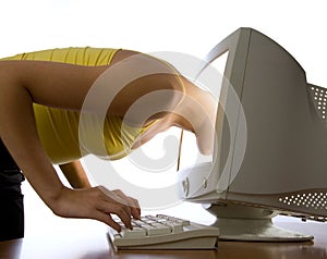 Girl looks at computer monitor
