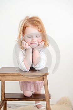 The girl looks dreamily down