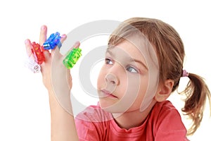 Girl looks at flashlights which are on fingers photo