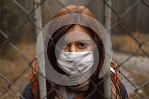 Girl looks like prisoner wears mask that protects againts the spread of coronavirus covid disease staying behind bars