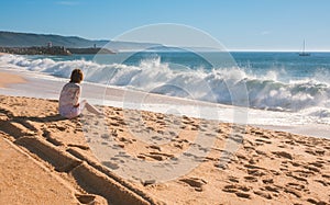 The girl looks at the ocean