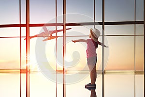 Girl looks at a plane at the airport