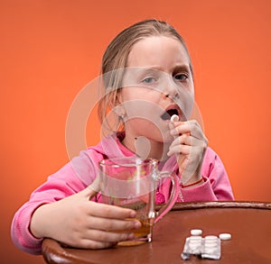 Girl looks very upset at the thought of taking her medicine