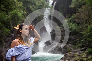 Girl looks at the waterfall