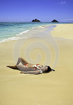 Girl lounging on the sand