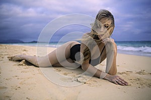 Girl lounging on the sand