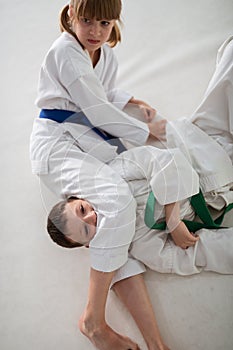 Girl loving aikido blocking boy while having aikido battle