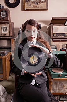 Girl with LP record in antique shop