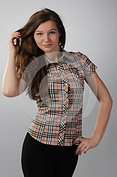 Girl with lush hair in a checkered shirt on