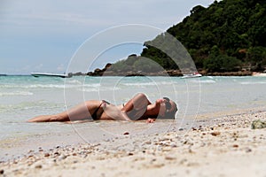 Girl lying on the beach.