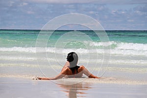 Girl lying on the beach.