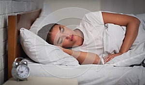 Girl Lying In Bed Suffering From Sleep Disorder At Home