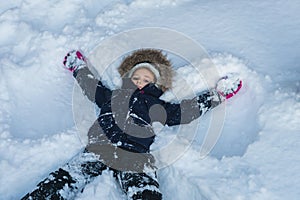 Girl lying in a deep snow