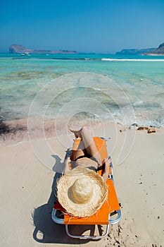 Girl lying down on lounger on Balos beach