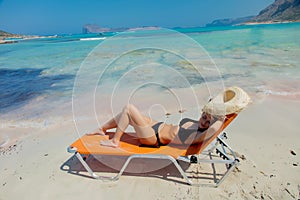 Girl lying down on lounger on Balos beach