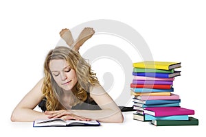 Girl lying on floor and reading, looking at book