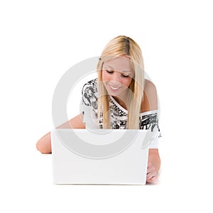 Girl lying on floor using laptop