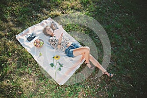 Girl lying on the grass and reading book