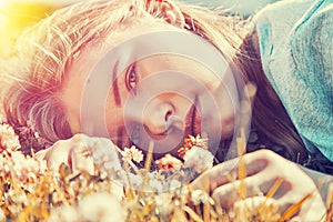 Girl lying on the grass on a Sunny autumn day
