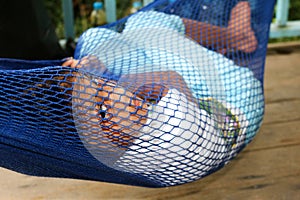 The girl lying in a hammock.