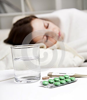 Girl lying near sick medicines
