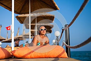 Girl lying on the pier. Attractive young woman in swimsuit lying on the pier. woman in swimsuit lying on the wooden pier on the