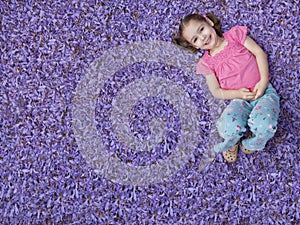 Girl lying on purple flowers