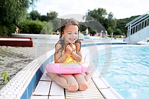 Girl lying by the swimming pool. Summer heat and water.