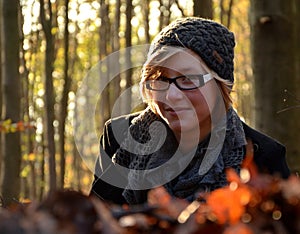 Girl lying in windfall beechen leaves