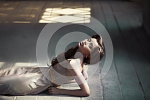 Girl lying on a wooden floor