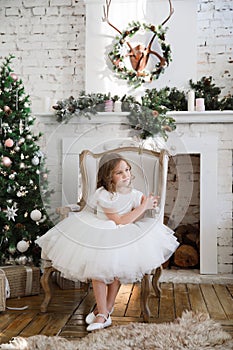 Girl with magic wands sitting in chair. Christmas