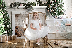 Girl with magic wands sitting in chair. Christmas